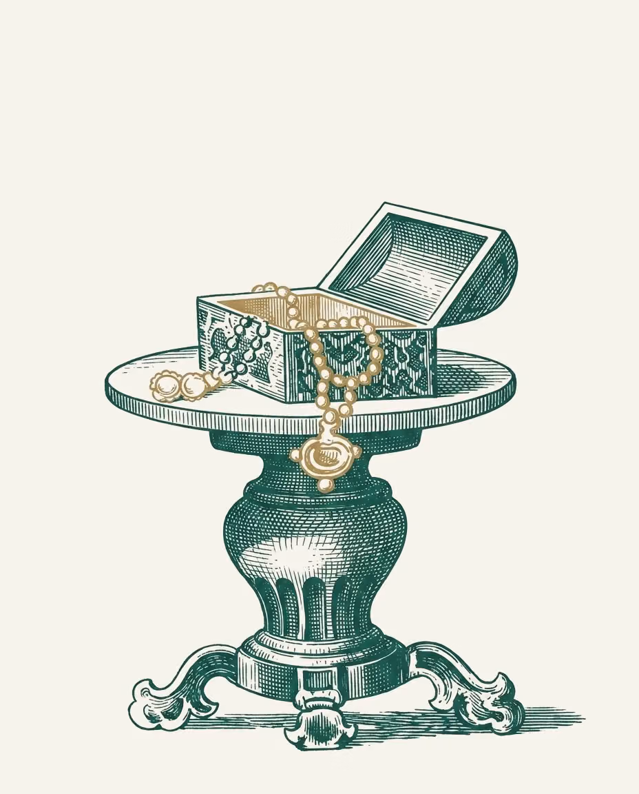 Incisione: un tavolino rotondo con un cofanetto di gioielli aperto, dentro una collana dorata.